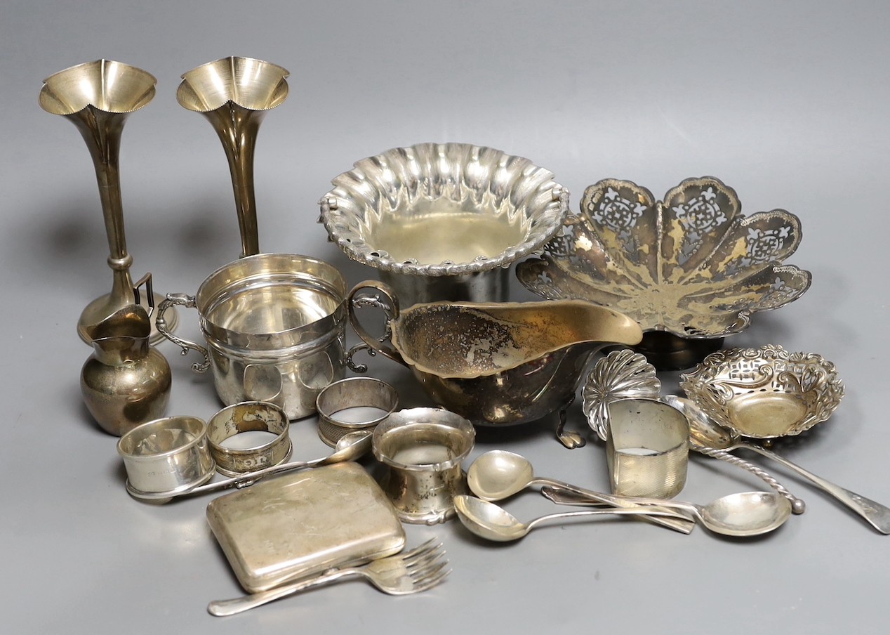 Assorted silver including a pair of posy vases, a small porringer, a pierced shallow bowl, a cigarette case, four napkin rings, a bonbon dish and six silver spoons, together with a French white metal cream jug and three
